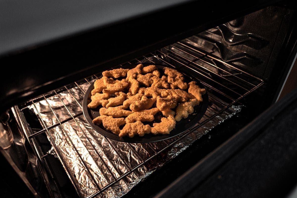 Food cooking on a tray inside a hot oven