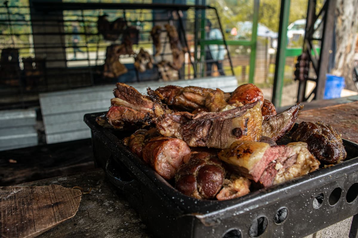 A platter of grilled food on a dark table