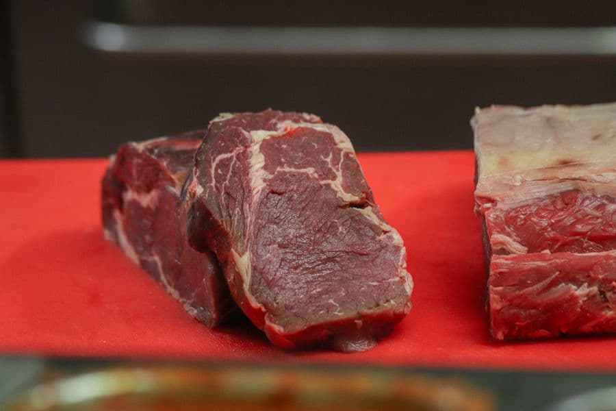 Raw cuts of beef on a butcher's board